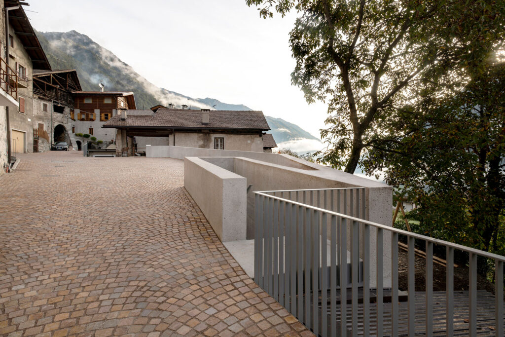A photograph showing a concrete staircase in a village in the Swiss Alps.